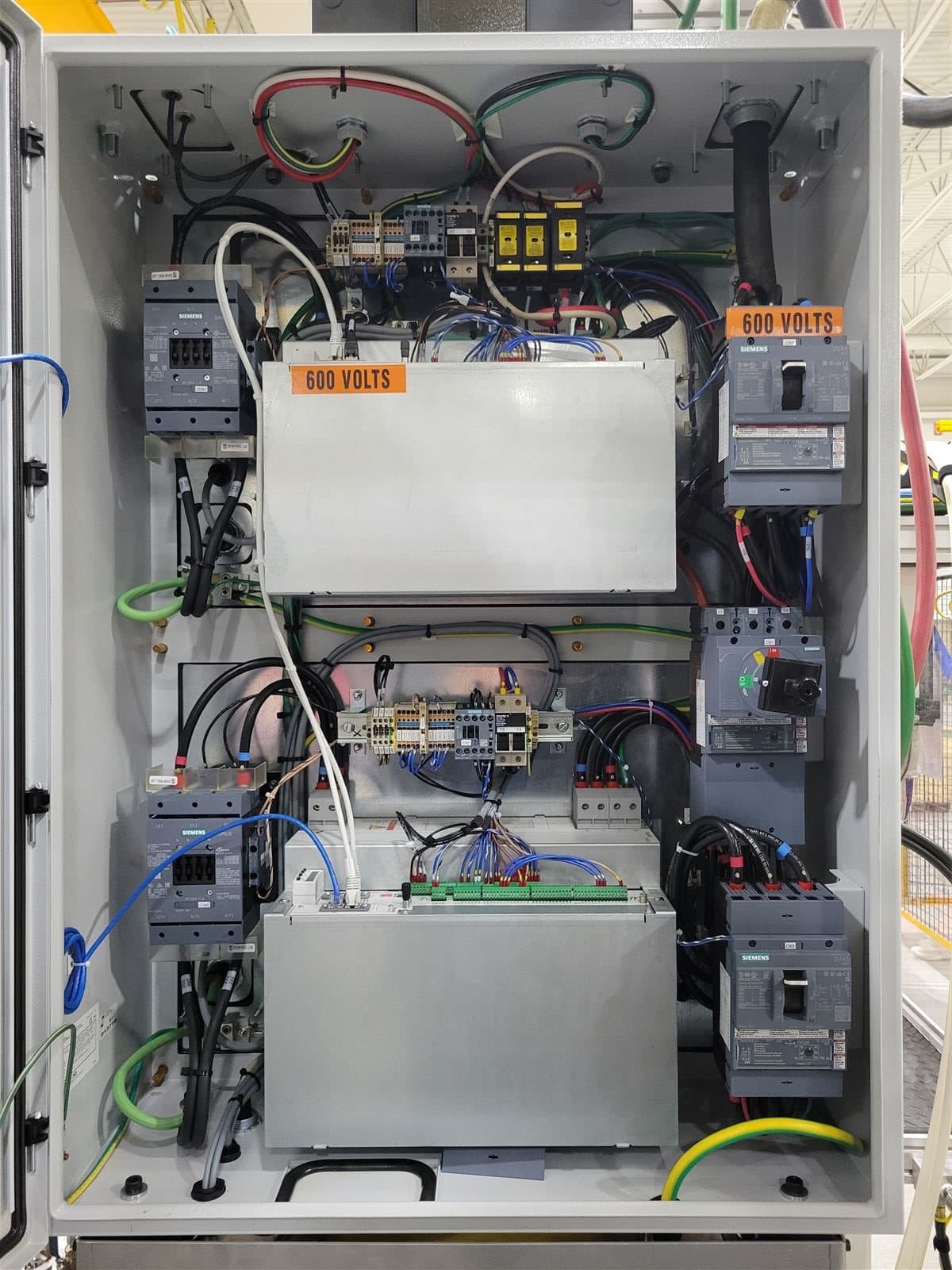 Industrial VFD control panel with 600 volt warning labels