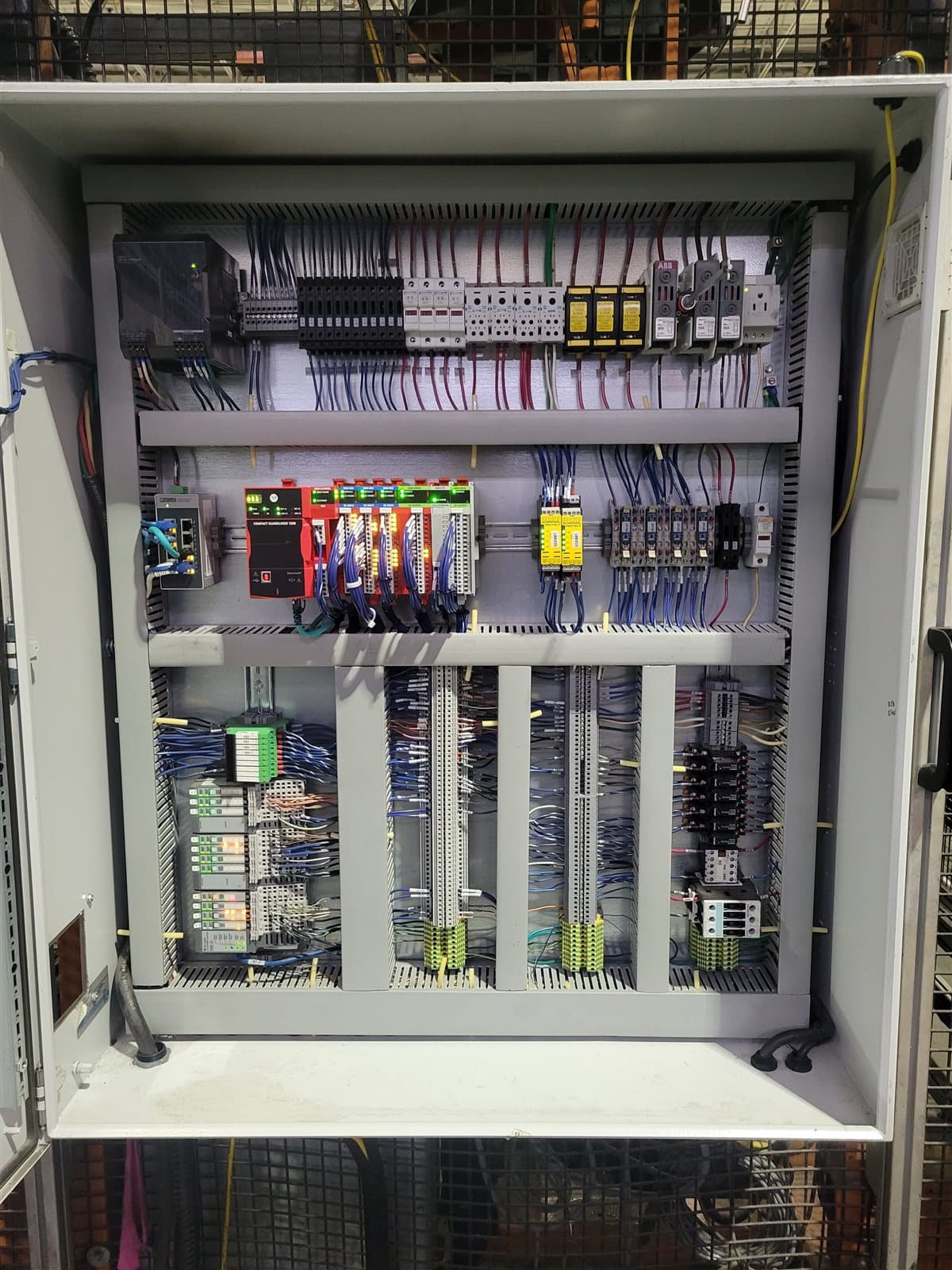 Densely wired control panel interior with multiple terminal block rows