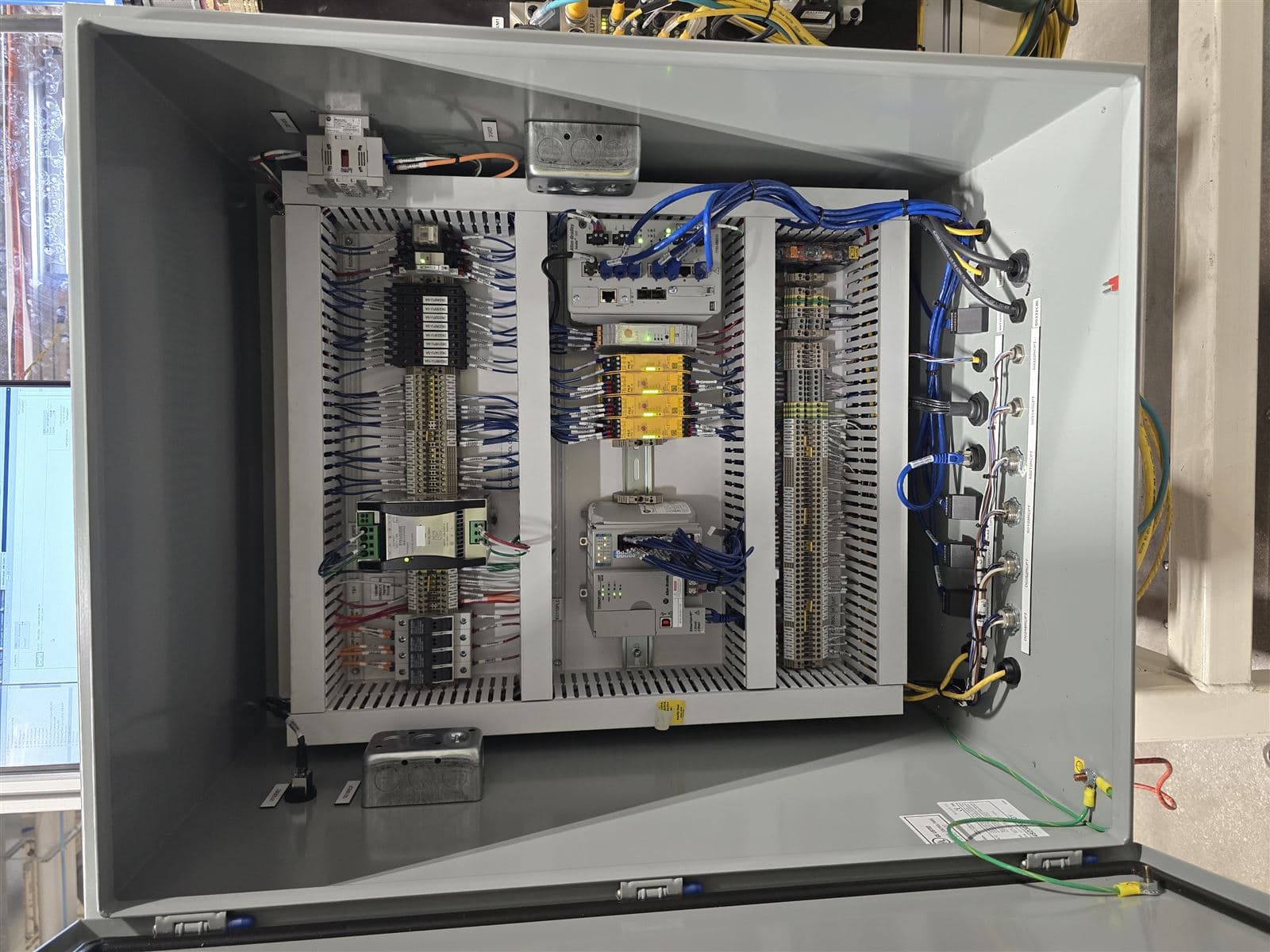 Multi-compartment industrial control panel with organized component layout