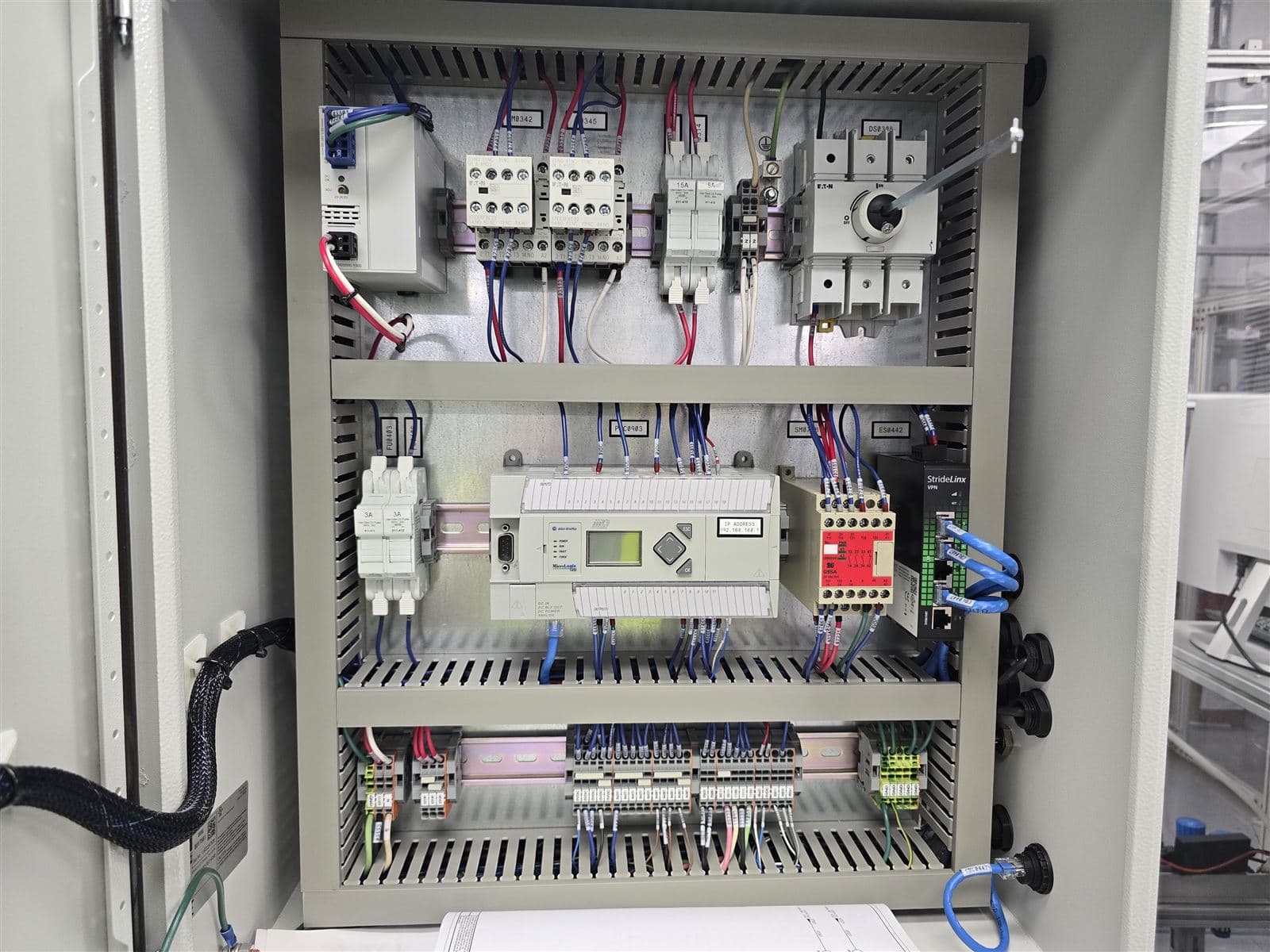 Machine control panel with PLC, HMI display, and contactor bank