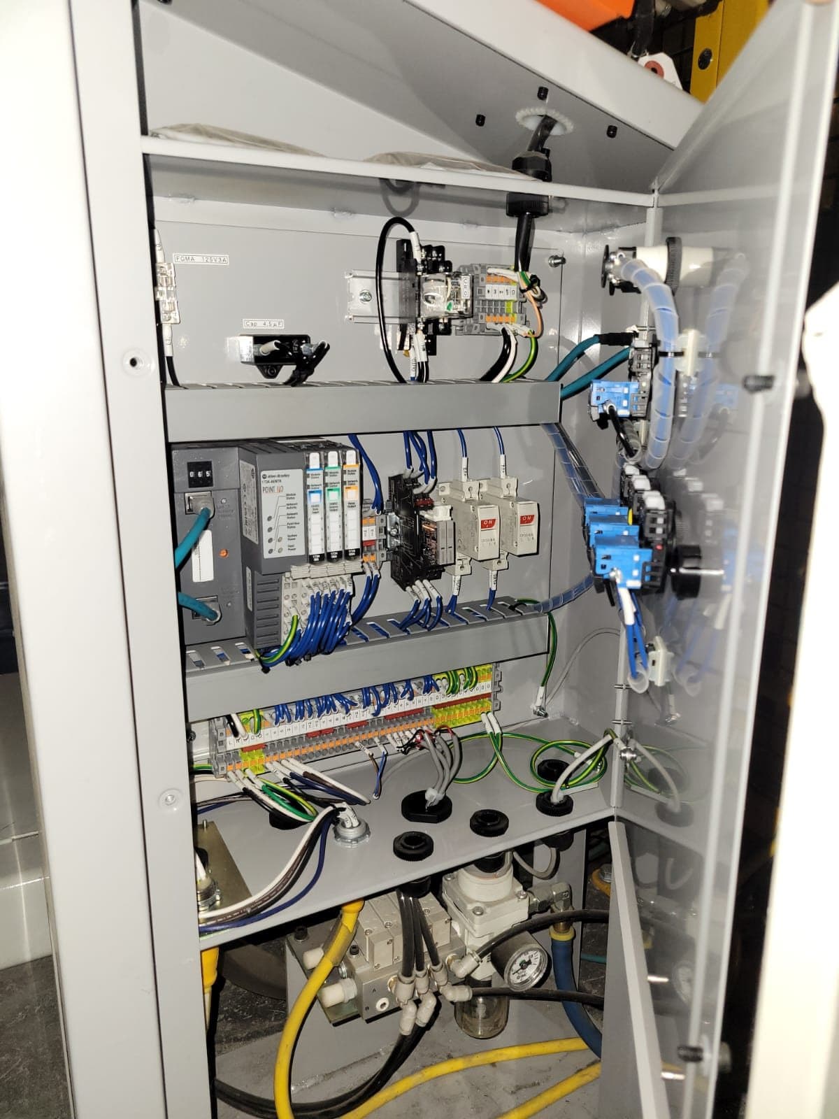 Tall control cabinet with pneumatic valve manifold mounted at the base