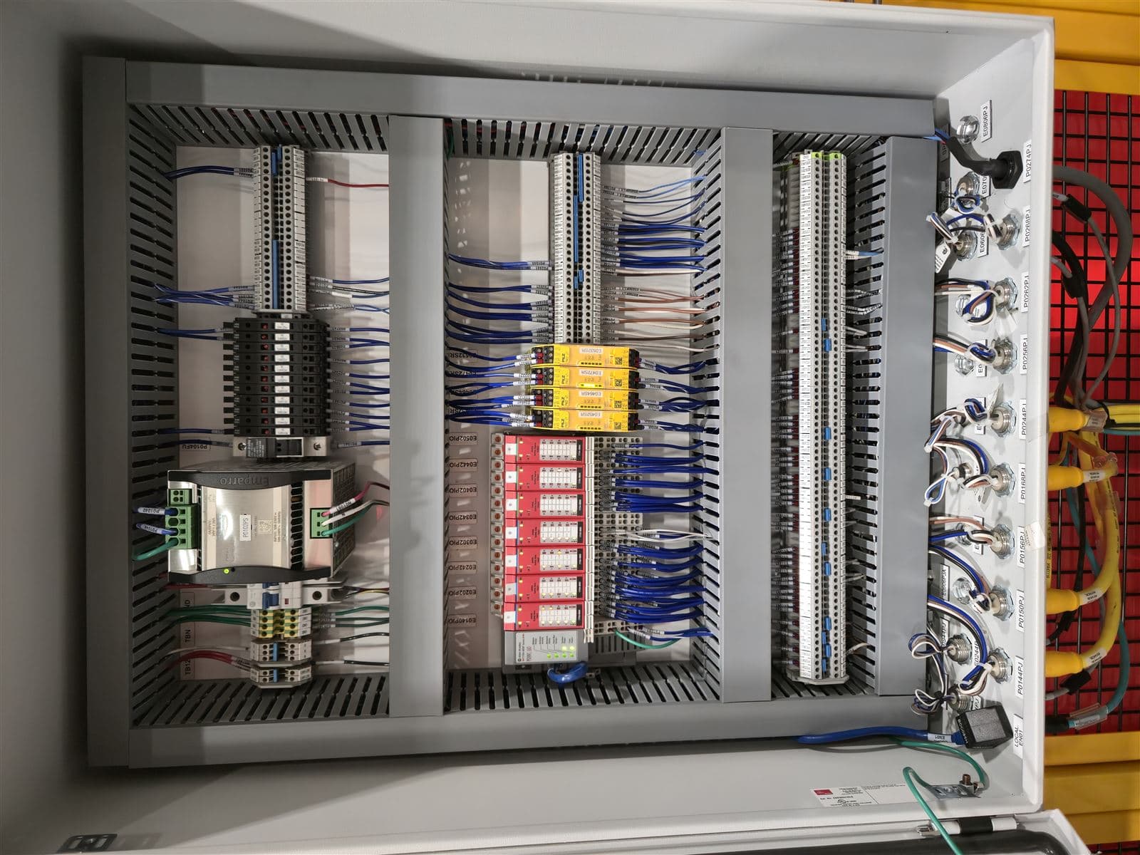 Remote I/O control panel with DIN rail terminal blocks and labeled wiring