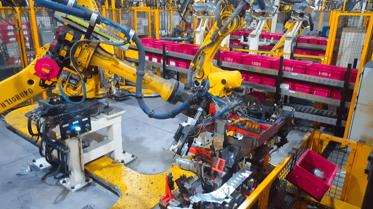 Dual robot resistance welding cell with material handling bins